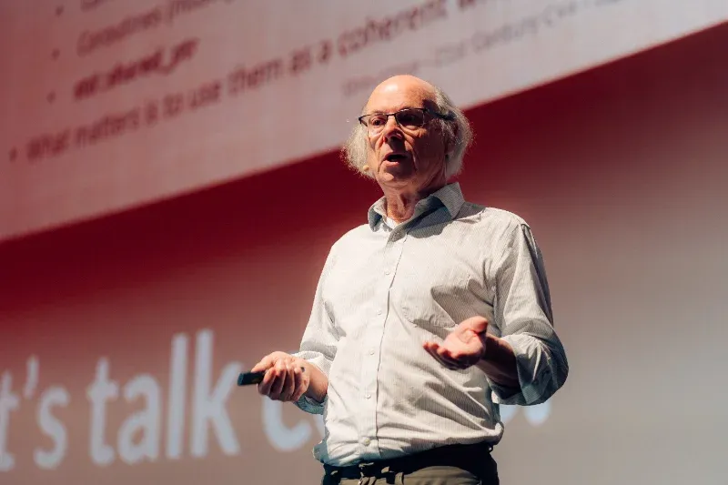 A speaker on the code.talks stage
